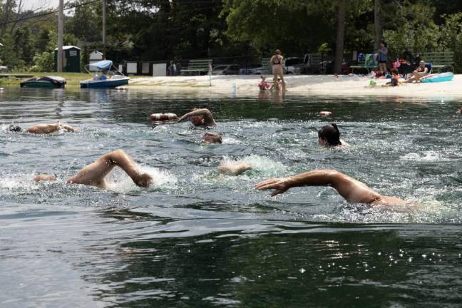 Going the distance Participants begin a 580-meter swim leaving from and returning to the Lindy’s Lake beach Sunday, Aug. 6. (Photo by John Caggiano)