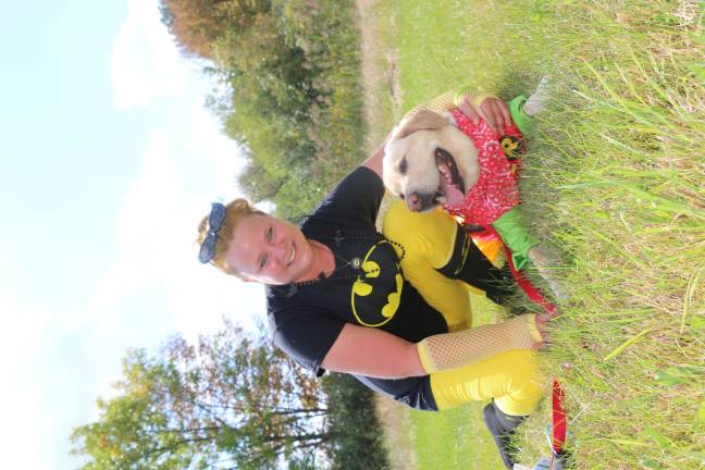 Pooches strut their stuff in Walk-a-Dog-athon Lynn Rhinesmith of West Milford and Brodie, dressed as the dynamic duo, Batman and Robin, tied for 1st Place in the best-dressed contest with Fawn Woods and Molly.