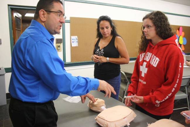 Photos by Linda Smith Hancharick Victor Ferrer, an Emergency Department nurse at St. Joseph's Regional Medical Center in Paterson, instructs Evelyn Glueck, left, and Melanie Dowling on administering Narcan to an overdose victim.