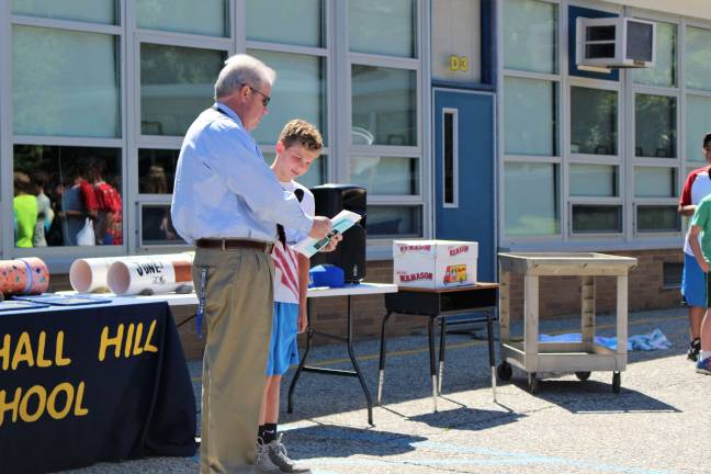 Marshall Hill School travels back in time Seamus McGuinness stands with his principal, Mike McCormick, at the start of the time capsule ceremony.
