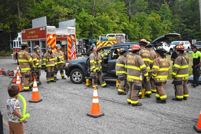 Community gathers for National Night Out Firefighters demonstrate use of the Jaws of Life tool.