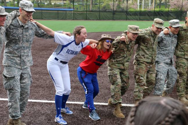 Einbinder relays and cheers with team members and ROTC members before the game.