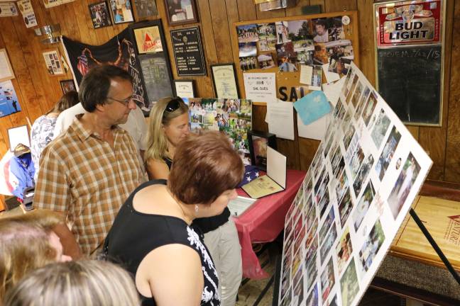A fitting farewell for an American patriot Friends and neighbors looked at the photos of Vonderhorst's life after the service.