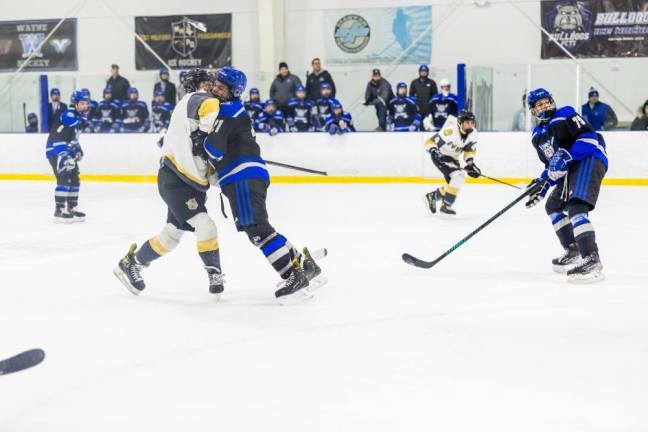 Players from each team clash on the ice.