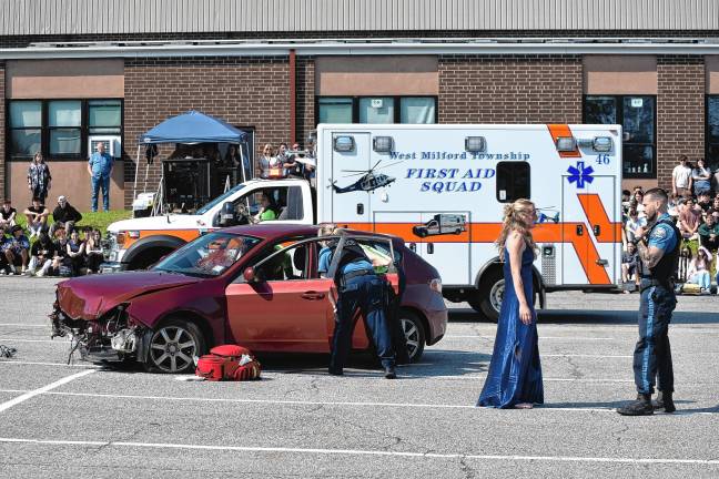 Simulated crash meant as warning Police talk to a student actor portraying one of those involved in the simulated crash.