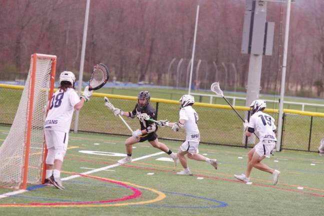 West Milford's Dylan Connors is pursued by Sparta defenders near the goal post. Connors scored three goals and made three assists.