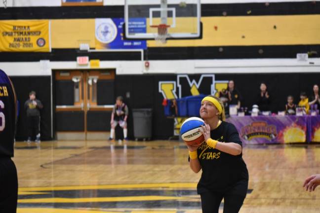 Paradise Knoll School fourth-grade teacher Katie Bonforte prepares for a corner jump shot against the Harlem Wizards.