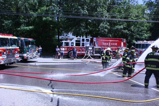 Community commissions Tanker 6 Ridge Road was the scene trucks, hoses and firemen. One can imagine what residents, unaware of the wet down celebration, must have been thinking. Photo by Ginny Raue