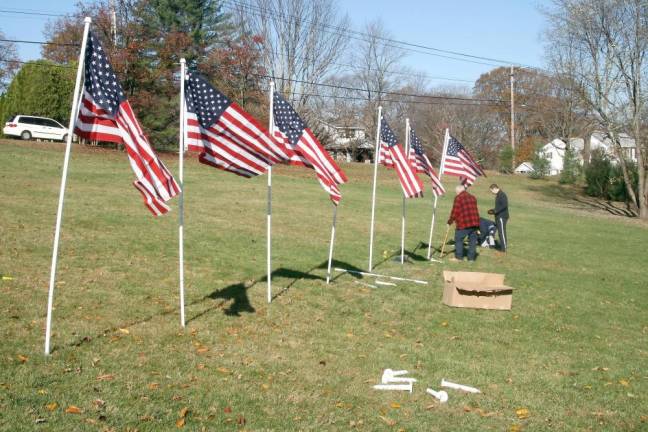 Rotary Club members set up the Flags for Heroes display at Bubbling Springs Park last weekend.