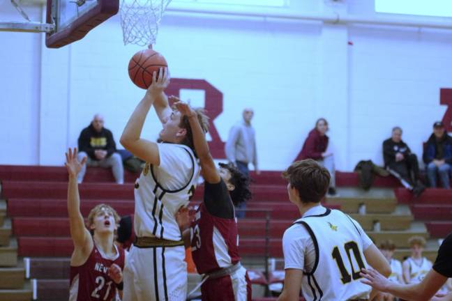 West Milford’s Connor Vogt takes the ball to the hoop during a shot. He scored 10 points, and the Highlanders won, 53-52. (Photos by George Leroy Hunter)