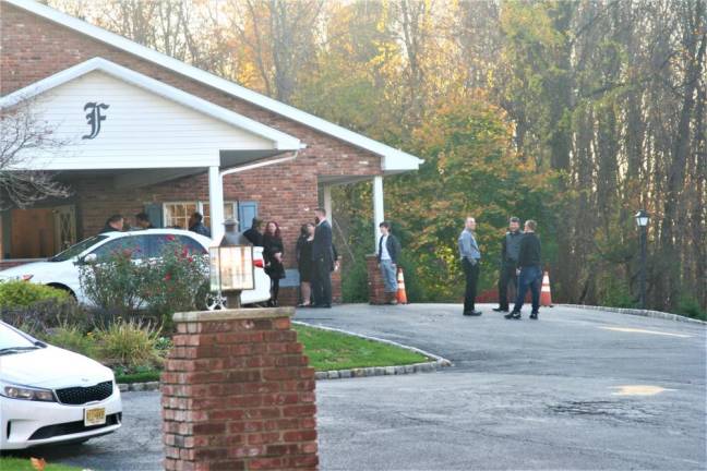 Family and friends gather for Jordin Tenk's memorial at Ferguson-Vernon Funeral Home Saturday.