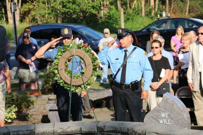 'Find that unity again' Members of West Milford's police and fire departments presented the wreath at the township's memorial.