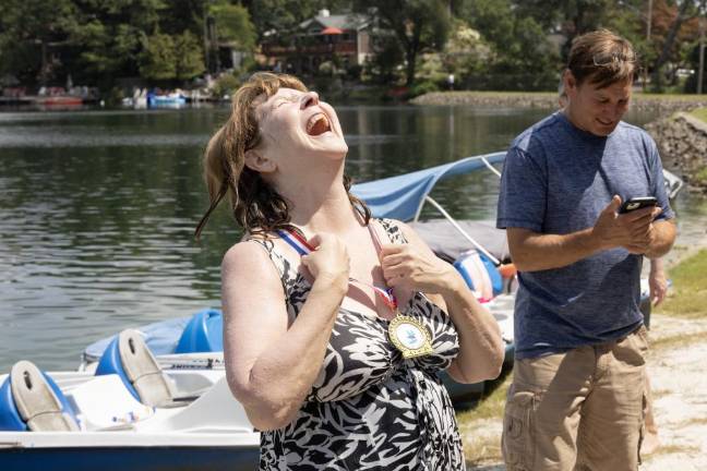 Going the distance A woman celebrates finishing the 580-meter swim. All participants received a medal.