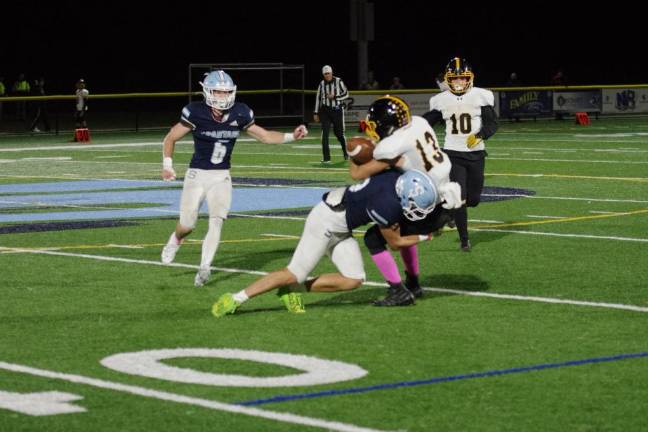 After catching the ball, West Milford wide receiver Jake Schwarzlow is taken down by a Sparta defender in the first half of their game Friday, Oct. 13. (Photos by George Leroy Hunter)