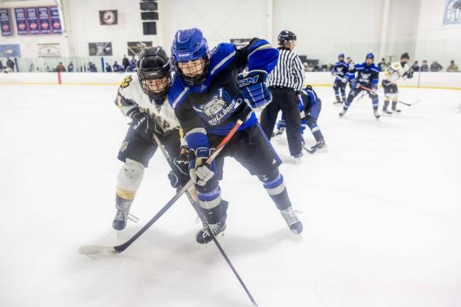 Players battle for the puck in the Passaic County Tournament finals Wednesday, Jan. 17. Passaic Tech defeated West Milford, 3-1. (Photo by Sammie Finch)