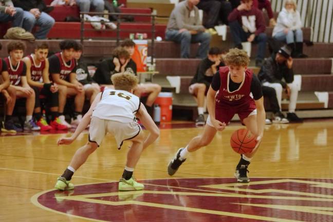 Newton’s Cooper Armstrong maneuvers the ball while covered by West Milford’s John DelVecchio in the first half.