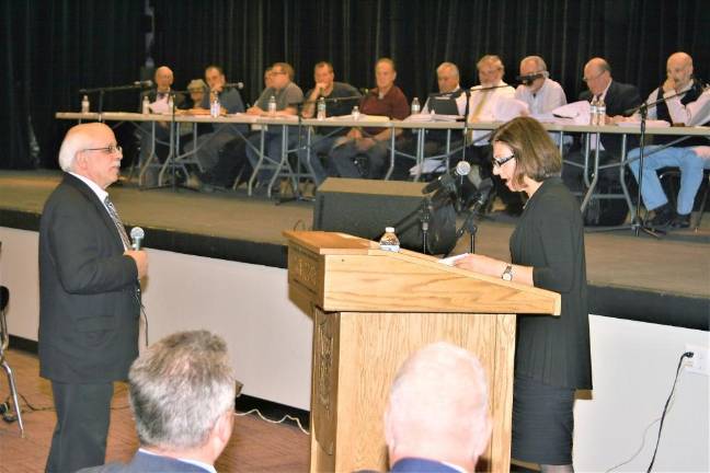 Green Meadow Organics Engineer Stephen Boswell, left, answers a question from an attorney objecting to the application at the Zoning Board hearing Tuesday night in the West Milford High School auditorium.