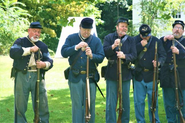 [Members of the 6th New Hampshire regiment Union Civil War reenactors hold a demonstration at the Long Pond Ironworks State Park in Hewitt on Saturday. Charles Kim photo]