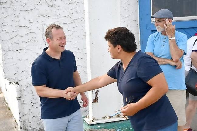 Congressman Josh Gottheimer shakes hands with Greenwood Lake Marina business owner Elena Dykstra.