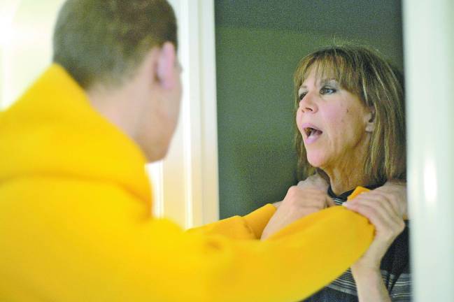 Maureen Morella guides her son, Jesse, back to his room after some physical therapy exercises. He suffered debilitating brain damage after experimenting with heroin.