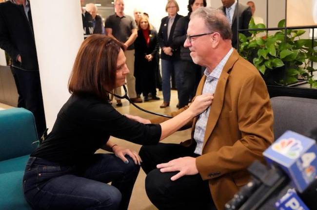 Kristina Moon listens to Rich Grehl’s heartbeat. He received the heart of her late husband, Billy, in a transplant last December. (Photos courtesy of LiveOnNY)