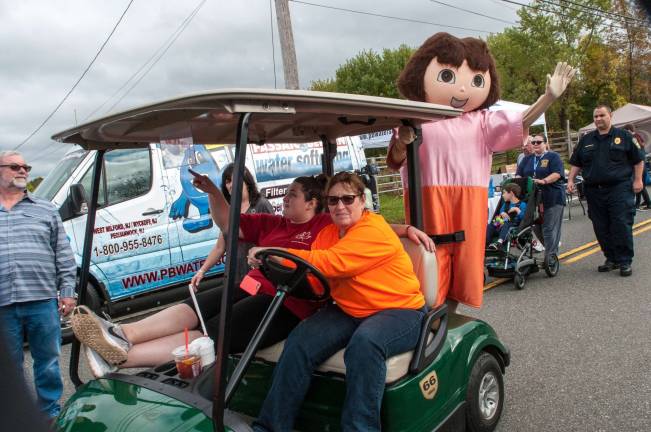 Township chalks up another great Autumn Lights Festival Dora, one of the costumed characters at the fest, waves to the crowds Saturday. photo by mark Cranston
