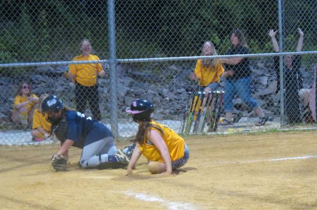 Softball season ends on a high note Gold scores with a close play at the plate.