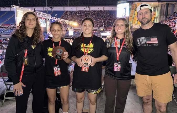 Girls on the field, ice, mat Warwick Valley High School's Victoria Alvarado, middle, and Monroe-Woodbury's Gail Sullivan are flanked by the Macalusos of Venom Girls Wrestling Club at last season's national championships in Fargo, N.D. (Photo provided)