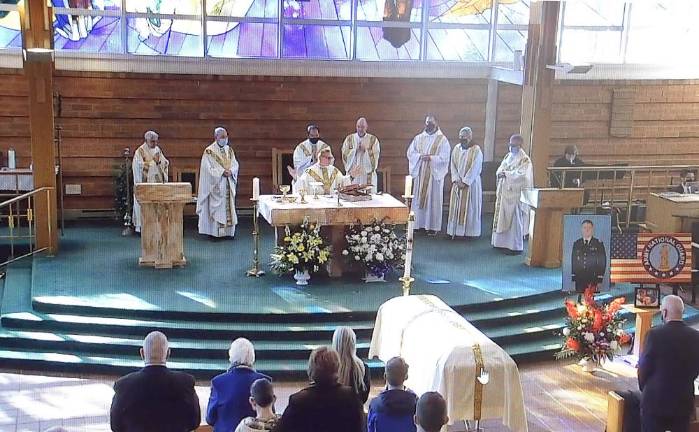 ‘He got cheated out of time, but he didn’t get cheated out of life’ The main concelebrant was Capt. Joseph Marcoux (center), a priest serving as a military chaplain. Other Concelebrants included St. Stephen’s pastor, the Rev. Jack Arlotta, and previous Pastor Rev. Michael McLoughlin.