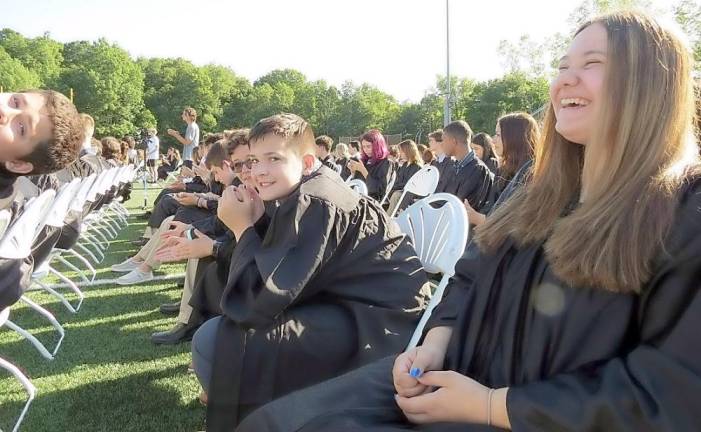 Students waiting to be called by name to receive their promotion certificate.