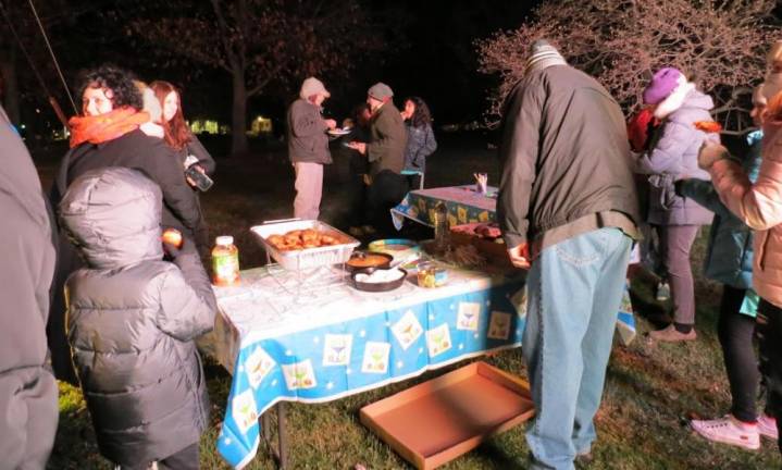 After the lighting, participants enjoyed some traditional Chanukah foods, including: fresh hot latkes with applesauce or sour cream, doughnuts and chocolate gelt.