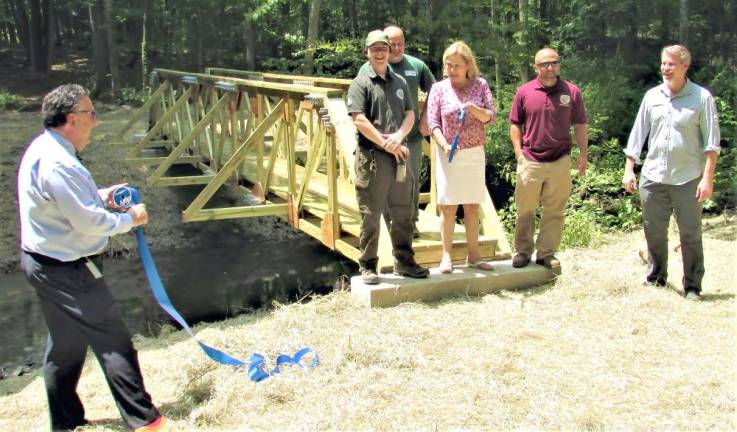 Passaic County Freeholder Director Cassandra Lazzara cuts the ribbon on a new bridge over Cooley’s Brook in 2018 as part of a continuing long term plan to make the park and trail network more accessible and convenient for residents.
