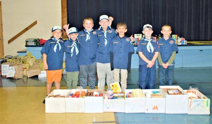 Scouts Gavin Lisbona, Douglas Lewis, Elias Poisson, Knox Goodman, Travis Blondin, Lucas McCrub, and Jacob Lederman get the donations ready.