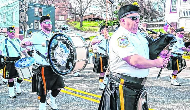 Members of the Police Pipes and Drums of Morris County play as they march in the Newton parade. (Photo by Nancy Madacsi)