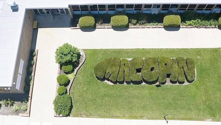 The sculpted hedges in the front of the school that reads “Macopin.”