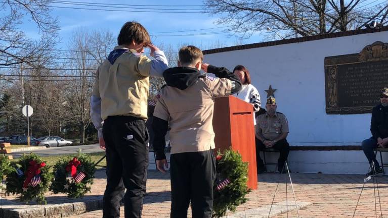 Scouts salute after placing a wreath.