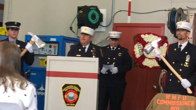 Deputy Fire Commissioner Richard Poplaski Jr. speaks during the service.