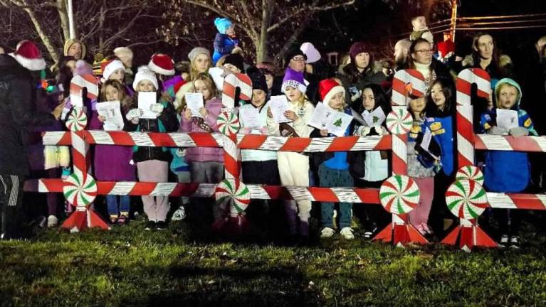 Children sing Christmas carols during the ceremony. (Photo by Rich Adamonis)