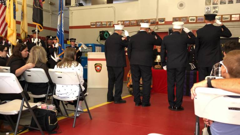 Firefighters salute Edward Steines during the memorial service.