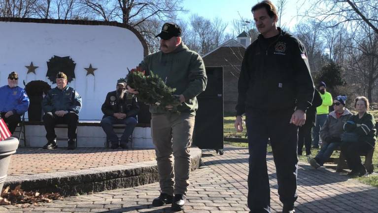 Residents prepare to place a wreath in honor of first-responders.