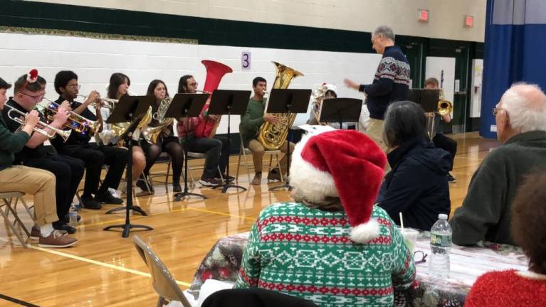 Choir, band entertain seniors HP1 Brian McLaughlin directs the West Milford High School Wind Ensemble Brass at a holiday party for senior citizens Thursday, Dec. 21.
