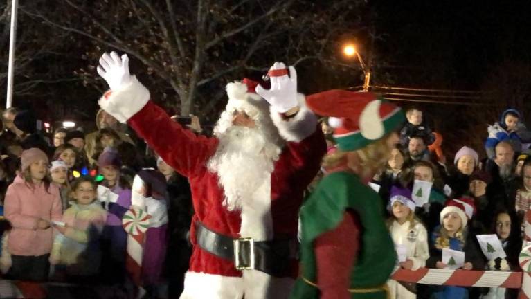 Santa makes his entrance after riding on a firetruck to the Christmas tree lighting ceremony Monday, Dec. 4 in West Milford. (Photo by Kathy Shwiff)