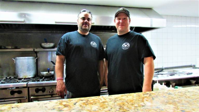 Steven Marquez and Greg Stouffer are ready to serve food at “Smoke Shack BBQ &amp; Burgers” restaurant at the Greenwood Lake Airport.