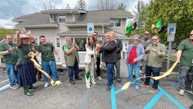 Jersey Roots owner Rachel Lyons and West Milford Mayor Michele Dale celebrate with Township Council members and others after cutting the ribbon Saturday, April 20. (Photo provided)