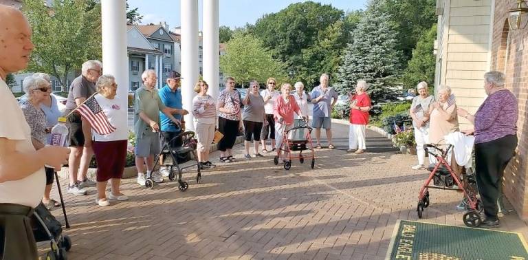 Some of the residents of the Bald Eagle Commons retirement community in West Milford got together to sing “God Bless America” to mark the 20th anniversary of the terrorist attacks on the United States. Photo provided by Marilyn Lichtenberg.
