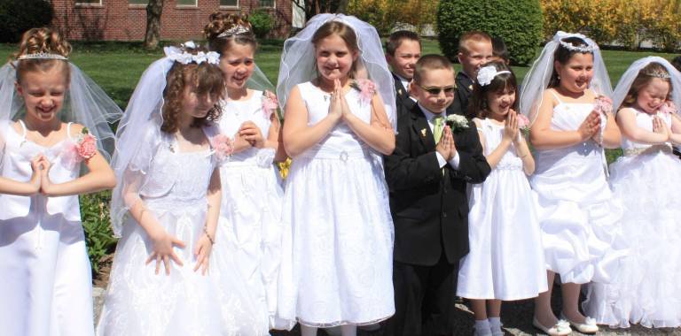 Beautiful spring day for Our Lady Queen of Peace First Communion Who's the coolest kid in this photo? While posing for photos after the Mass, squinting in the early afternoon sun was almost unavoidable. Except for Tyler Rubenacker, center, perfectly comfortable in his shades. Pictured here from left in front are Brooke Borntager, Madison Borsetti, Hailey Clarke, Jenna Hodgson, Tyler Rubenacker, Sara LaManna, Gabriella Meza and Izabella McLean. Back row, Evan Redl, Logan Rivera and Michael Sciarra.