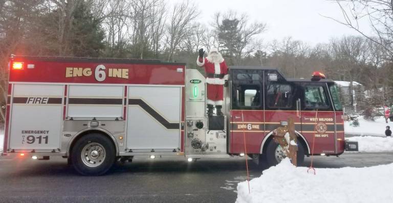 The Big Man in Red had a “ho ho ho” for everyone who could hear him. Photo by Patricia Keller.