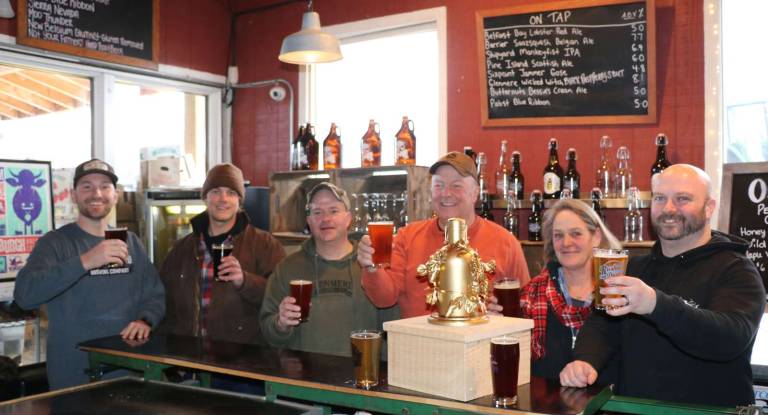The prize Photo by Roger Gavan The Gilded Growler local craft brewery tournament at The Cafe at Pennings Farm Market will kick off March 24. Pictured with the Gilded Growler are, from left: Pine Island Brewing owner Mike Kraai, Pennings Cidery manager S.J. Pennings, Glenmere Brewing Co. owner Frederick Mehler, Pennings Farm Market owner Steve Pennings, Gilded Growler artist and Pennings Garden Center associate Hilda Luce and Pennings General Manager Brien Milbauer.