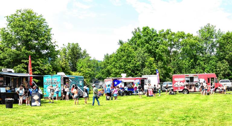 Crowd enjoys food, music, fun Eight food trucks line up along the edge of the field.