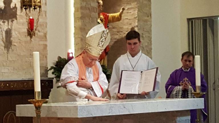 Bishop consecrates new altar at Our Lady Queen of Peace Photos provided Bishop Arthur J. Serratelli annoints the new stone altar at Our Lady Queen of Peace Church in Hewitt.